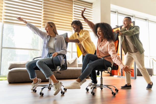 istock Office workers having fun racing on chairs in the workplace 2180342513