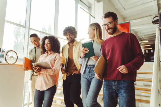 istock Diverse group of students walking up stairs in university hallway 2180342517