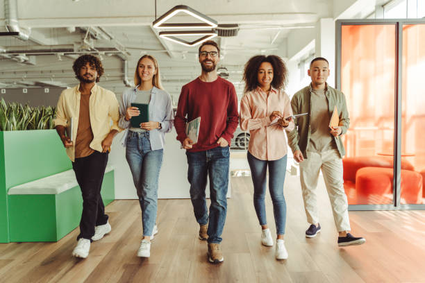 istock Group of diverse business people walking in modern office 2180342520
