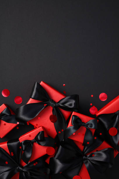 istock Black Friday gift boxes with black ribbons on a dark background 2180342651