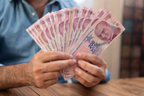 istock Entrepreneur holds Turkish lira banknotes demonstrating quantity after currency exchange procedure 2180346959