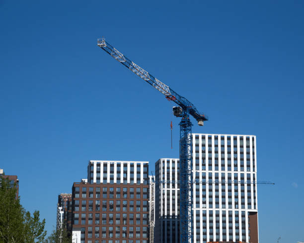 istock Construction site tower crane and new buildings at blue sky background 2180349545