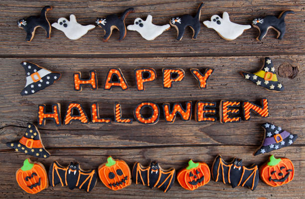 istock Happy Halloween with gingerbread handmade cookies on rustic wooden table 2180350680