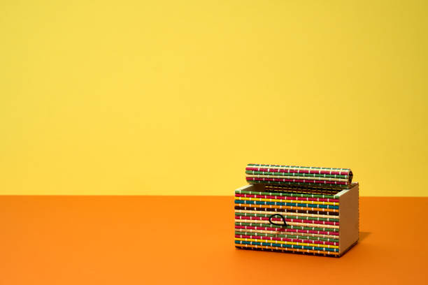 istock Colorful wooden handmade box on yellow background. 2180351089