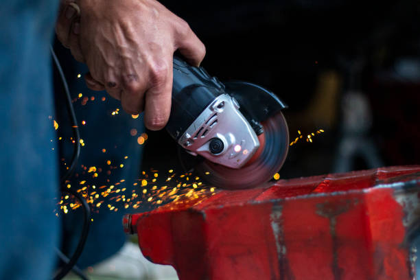 istock A skilled worker uses a handheld angle grinder to cut through metal, creating sparks in a workshop setting during late afternoon 2180353693