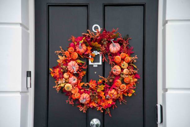 Halloween decorated outdoor cafe or restaurant terrace in America or Europe with autumn wreath traditional attributes of Halloween. Frontyard decoration for party.