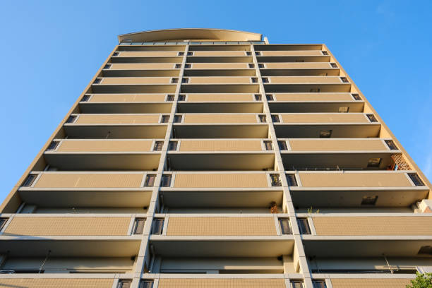 Low angle view of rows of balconies against a clear blue sky.