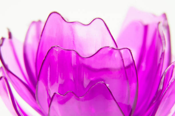 Purple plastic flower petals on a white background