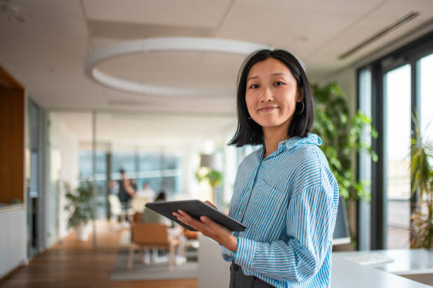 istock Asian Businesswoman in Modern Office Setting 2180360990