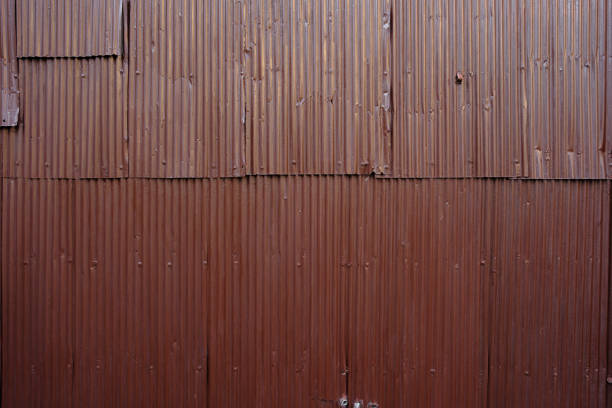 Large brown corrugated iron panels bolted together to make a wall.