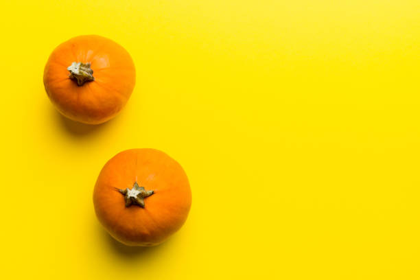 istock Autumn composition of little orange pumpkins on colored table background. Fall, Halloween and Thanksgiving concept. Autumn flat lay photography. Top view vith copy space 2180374905