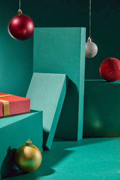 istock Christmas-themed photoshoot, with empty space for product display showcasing rectangular platforms, Christmas decorations placed on top, next to two rectangular panels leaning against each other. 2180388824