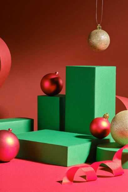 istock The Christmas-themed graphic template, features four green rectangles with green cylinder empty platforms, a red paper strip, and a red ribbon as decorations in the red background. 2180389497