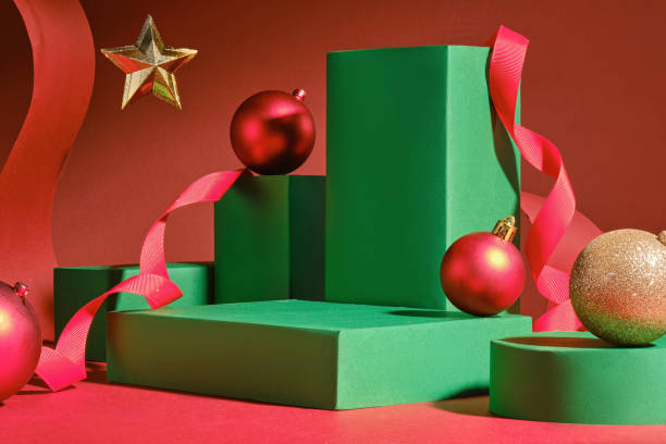 istock Four green rectangles with green cylinder empty platforms, decorated by Christmas balls, a red paper strip, and a red ribbon are perfect for the image template, Christmas vibes displaying product. 2180389501