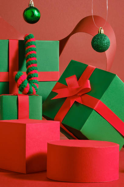 istock A red cylindrical podium, arranged on the red surface next to green and red gift podiums, with baubles and accessories. Ideas for Christmas concept empty space on the podium of product presentation. 2180389538