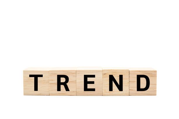 istock Wooden cube blocks with TREND text isolated on white background. TREND words. Copy space and Clipping path. 2180397633