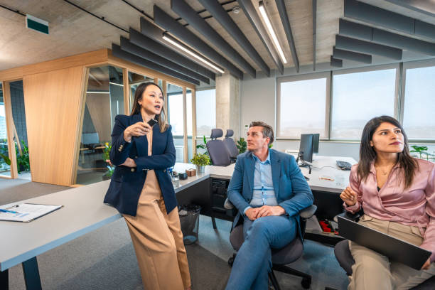 istock Diverse Executives in Strategy Session at Modern Office 2180398112