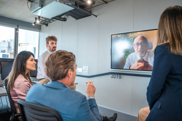 istock Diverse Team in Discussion with Senior Manager via Video Conference 2180398117