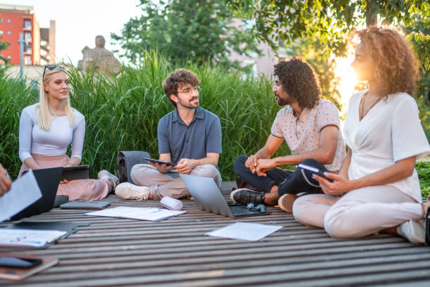 istock Diverse Team in Outdoor Business Strategy Session 2180398529