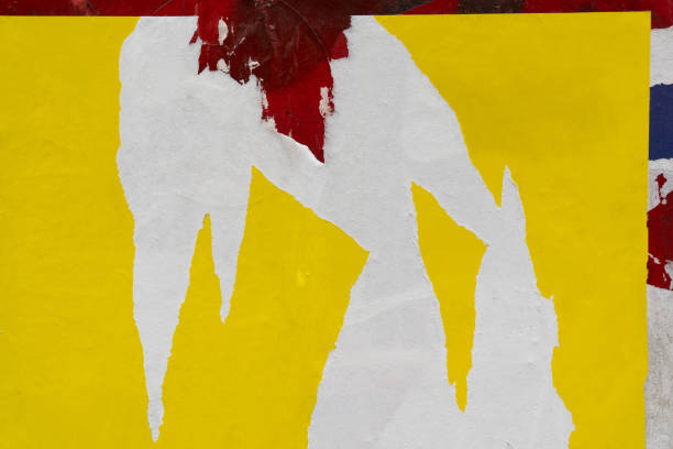 Peeled yellow paper poster on a red wall