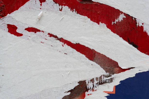 Peeled red paper poster on a wall