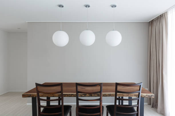 istock Modern Dining Room Interior with Wooden Table and pendant lights 2180405550