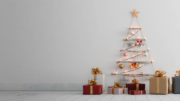 istock A tree-shaped Christmas decoration hangs on a white wall, with several gift boxes in front.3d rendering 2180408107