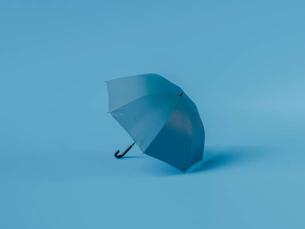 istock Blue umbrella standing on blue background symbolizing blue monday 2180410942