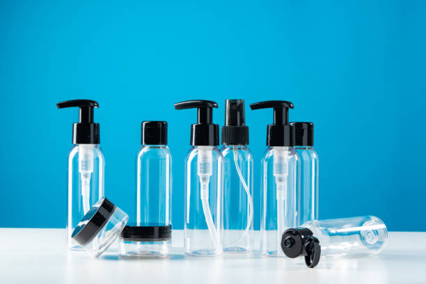 istock Clear plastic bottles with black caps arranged on a white surface against a bright blue background 2180411877