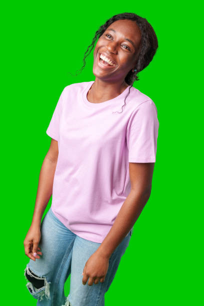 istock A joyful young woman smiling brightly while standing against a vivid green background 2180412382