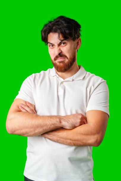 istock A man makes a funny face while posing against a bright green background 2180413092