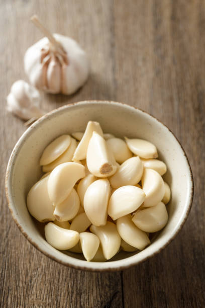istock Garlic cloves and garlic on wooden board 2180414069