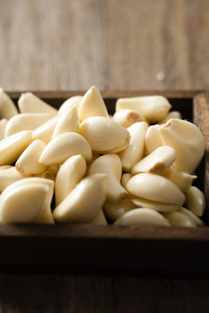 istock Garlic cloves and garlic on wooden board 2180414072