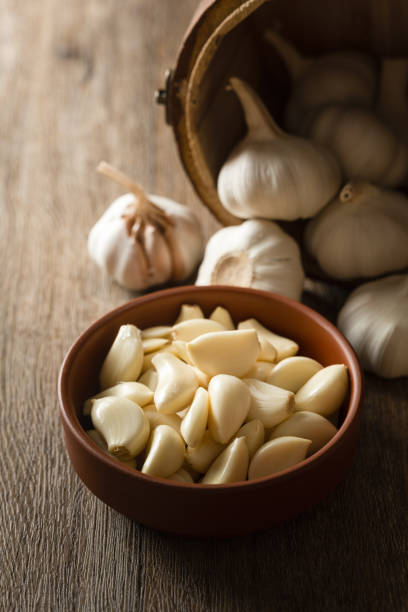 Garlic cloves and garlic on wooden board