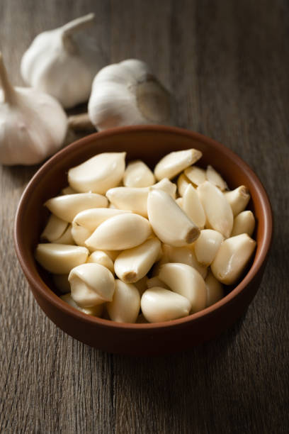 istock Garlic cloves and garlic on wooden board 2180414150