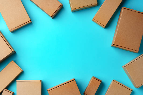 A collection of cardboard boxes arranged on a bright blue surface