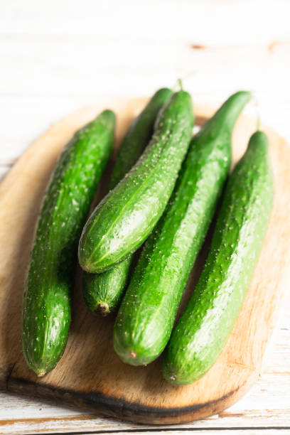 istock fresh cucumbers on a white wooden table 2180414320