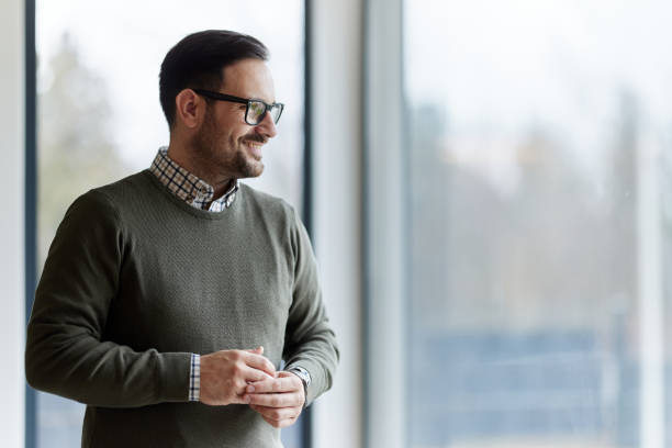 istock Happy man day dreaming by the window. 2180415250