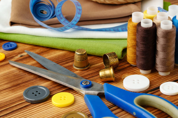 istock Crafting tools and materials arranged on a wooden table for sewing projects 2180415959