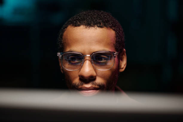 istock Focused African American Male Wearing Glasses at Computer 2180416872