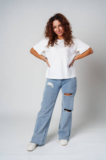 istock Young woman posing confidently in casual attire against a neutral backdrop 2180417041