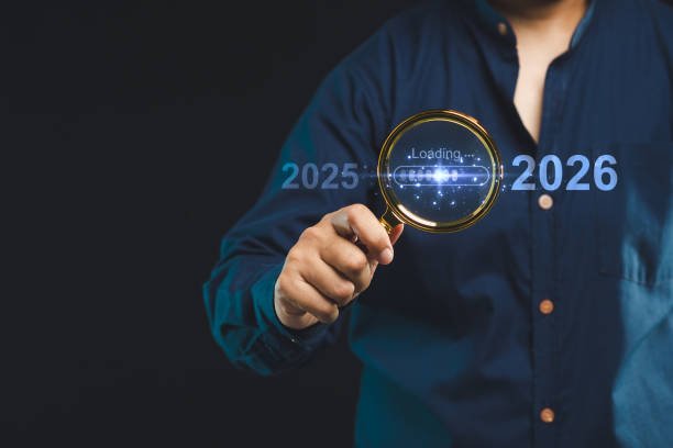 istock Man holding magnifying glass with digital loading bar 2025 to 2026, future vision concept 2180417863