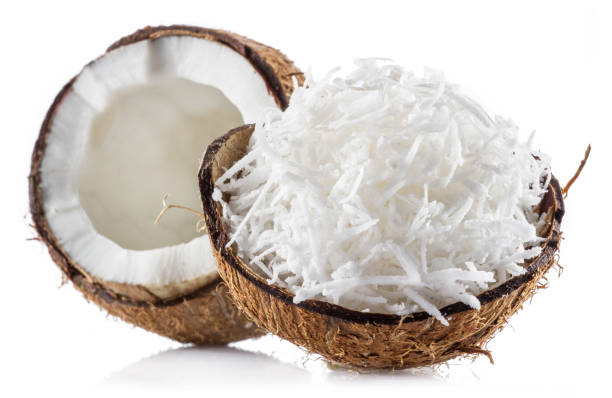 istock Grated coconut pulp in cracked coconut shell and half of split coconut on white background. File contains clipping path. 2180418275