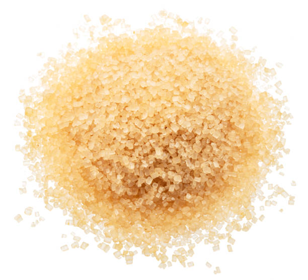istock Heap of light brown cane sugar, isolated on white background. 2180418429