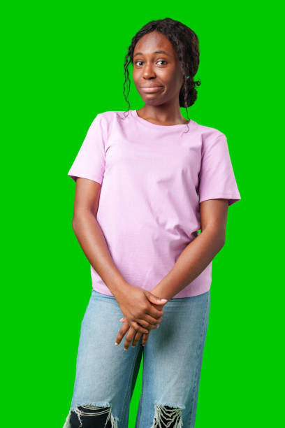 istock Young woman with curly hair shows a skeptical expression against a bright green background 2180418568
