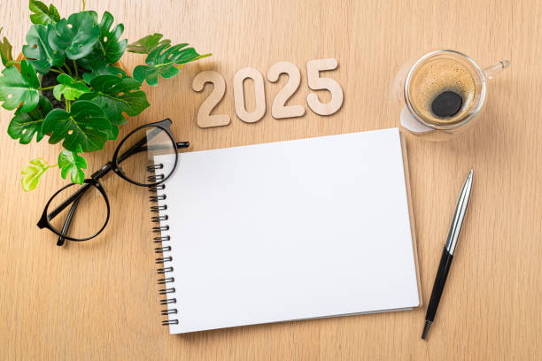 istock New year resolutions 2025 on desk. 2025 resolutions list with notebook, coffee cup on table. Goals, resolutions, plan, action concept. New Year 2025 template 2180419278