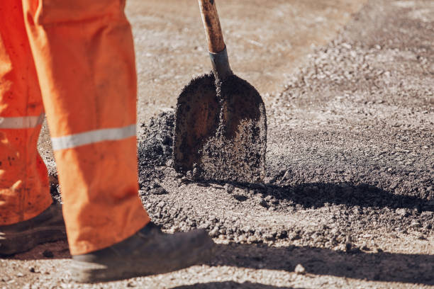 istock Construction workers working on a new asphalt layer on a public street. 2180420817