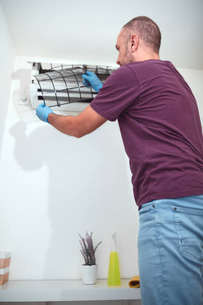 istock Man cleaning and maintaining air condition unit at home. 2180420970