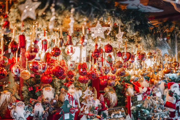 istock Christmas markets assortment. Festive decorations and decor in bright red tones in the light of garlands.Christmas Shopping. Buying gifts and decorations at Christmas fairs 2180421930