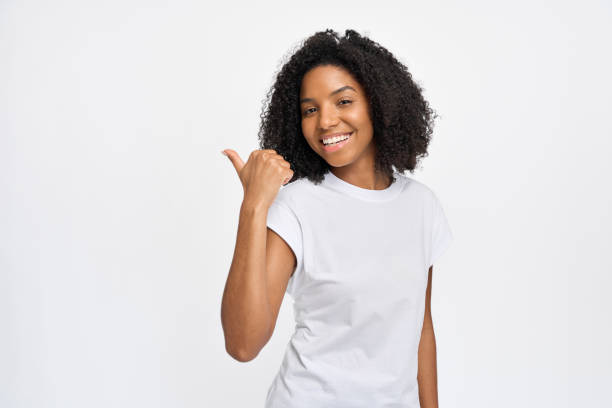 istock Happy young African girl pointing at copy space isolated on white background. 2180423071